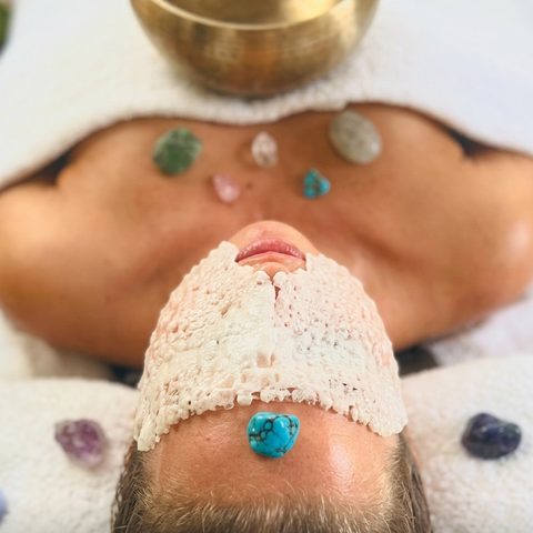 Restorative facial in progress, held with presence and care